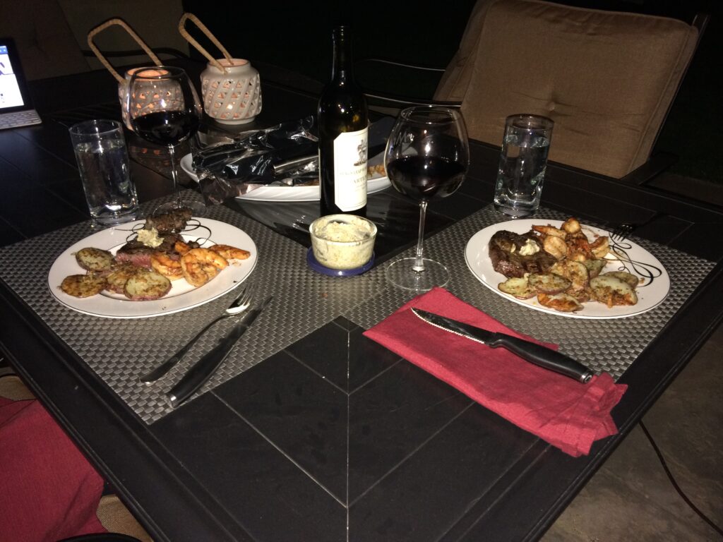Rib Eye Steak, Jumbo Shrimp, Parmesan Crusted Potatoes, and a nice bottle of wine.